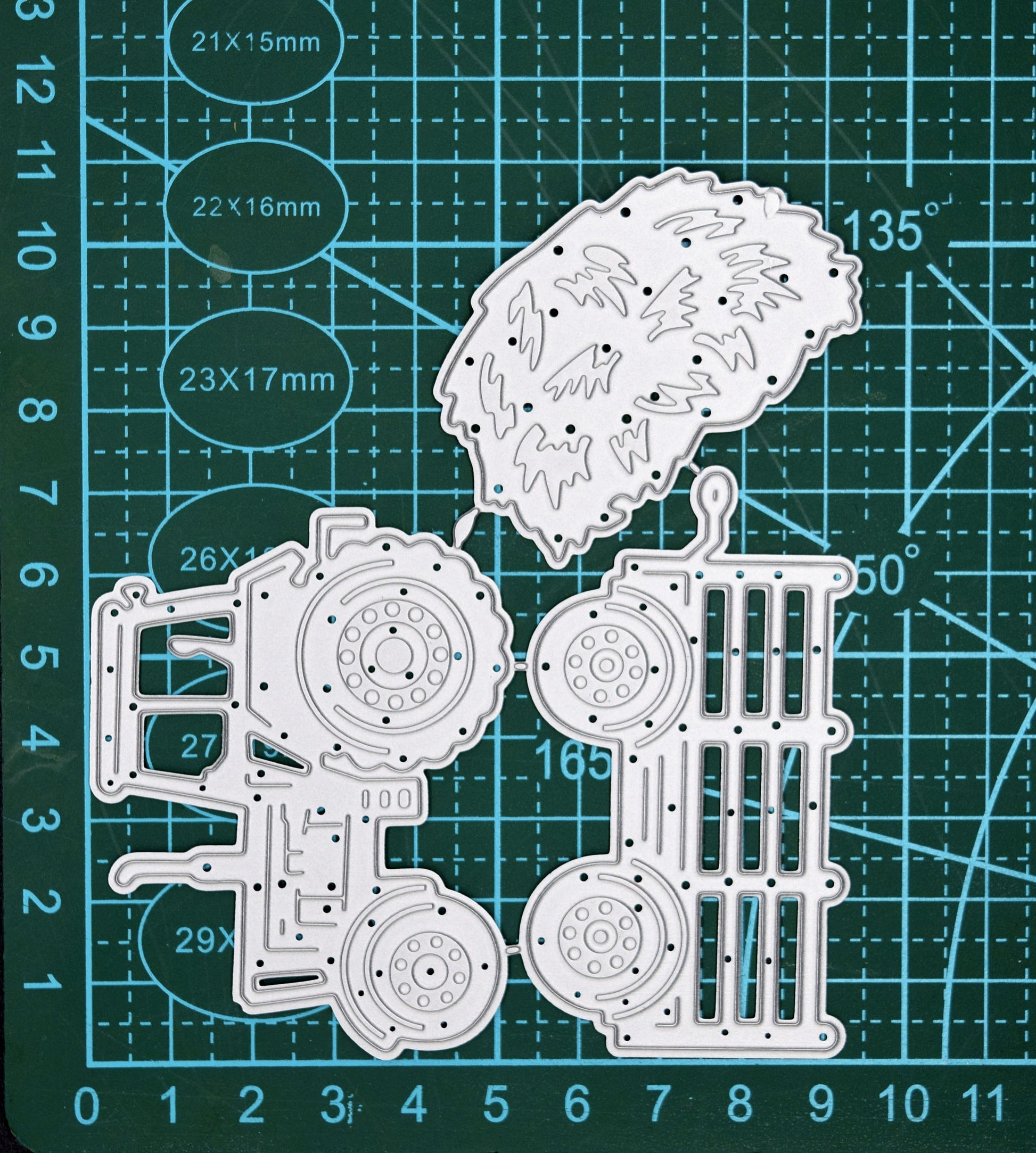Tractor and trailer metal cutting dies set on cutting mat showing size and detail of farm scene dies