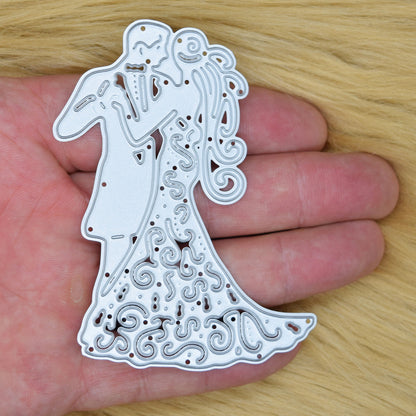 Bride and groom cutting die shown in hand for size reference