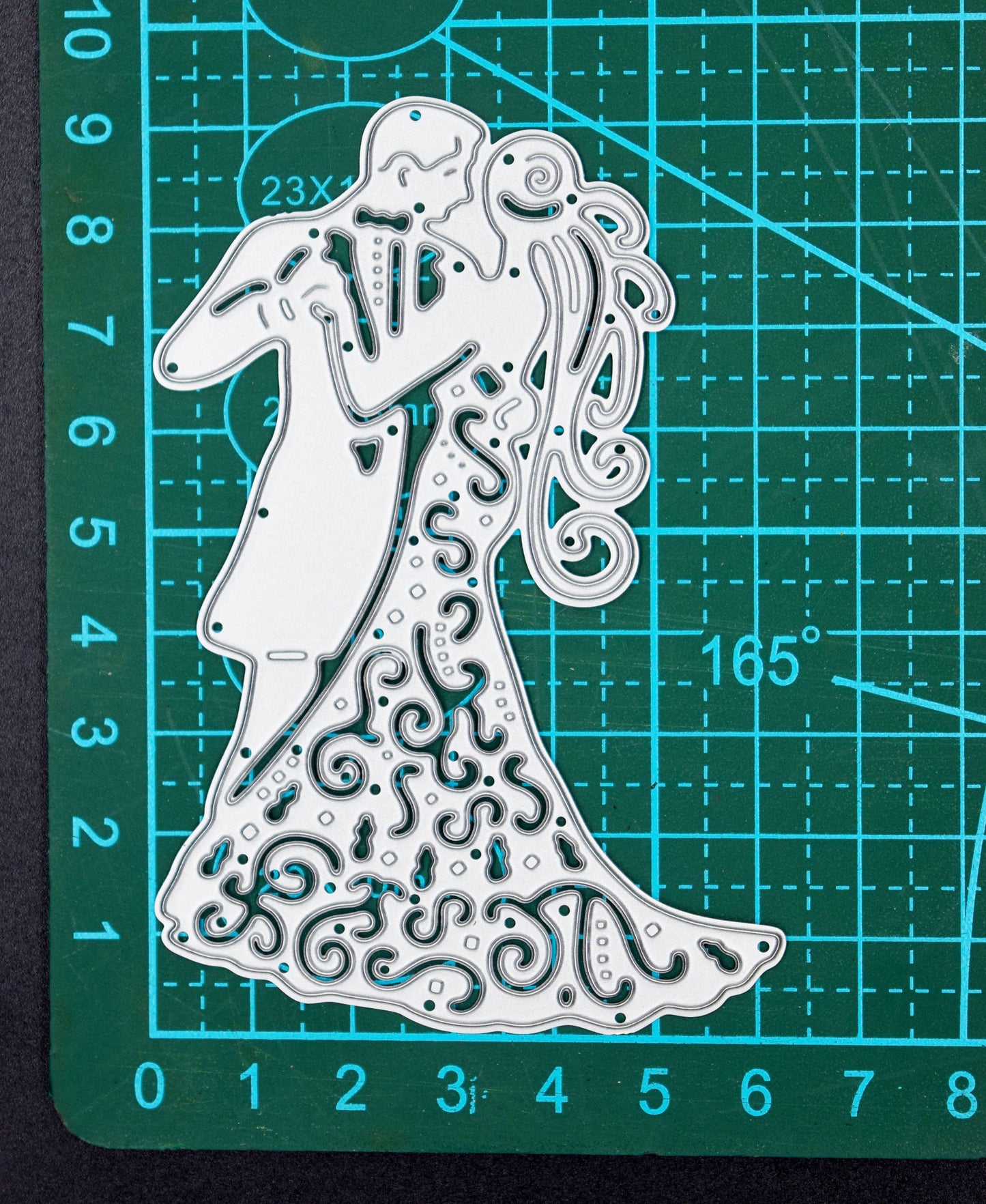 Bride and groom metal cutting die on cutting mat showing size