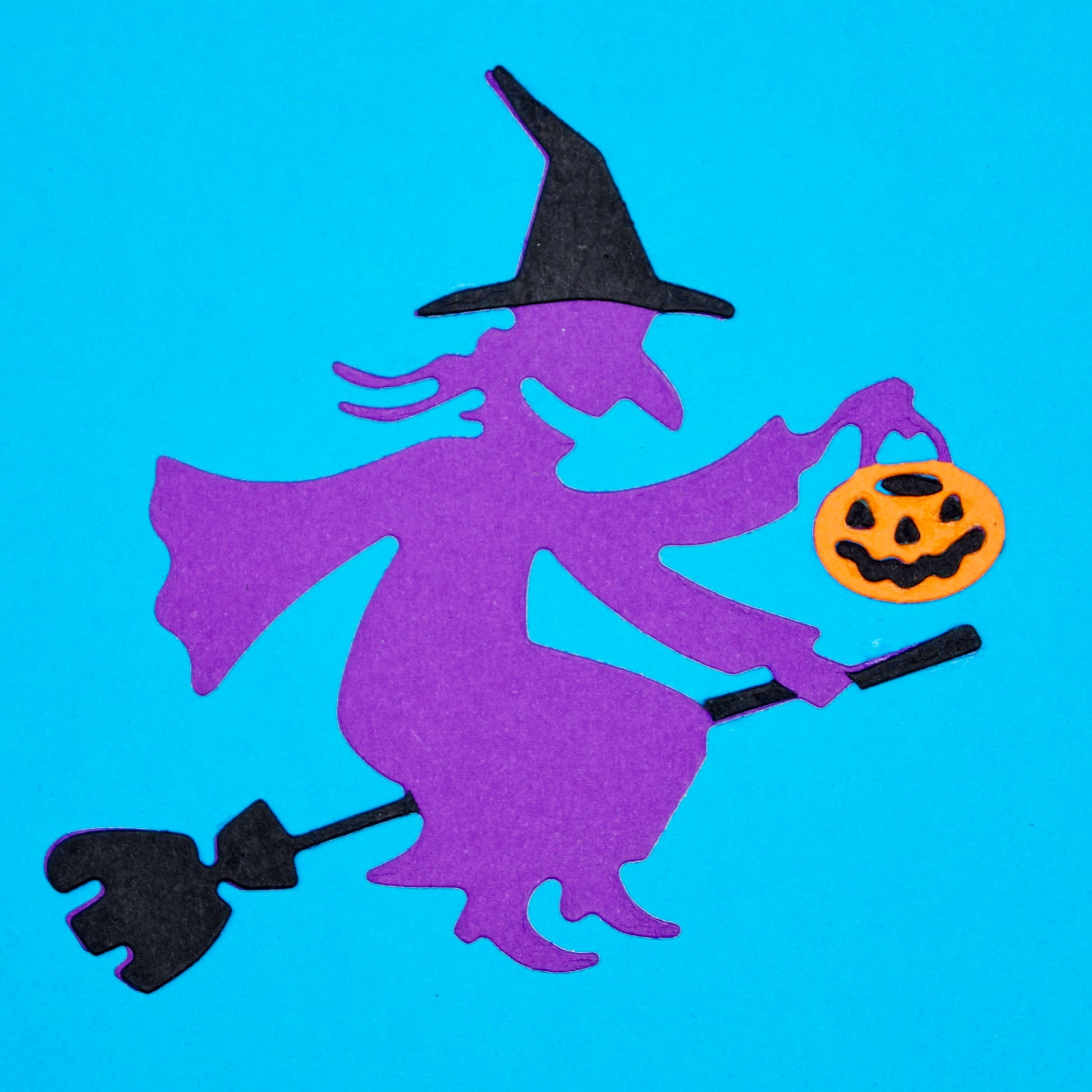 Witch on broomstick die cut in coloured card